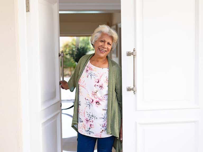 woman at the door in senior living facility